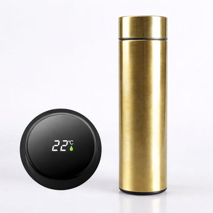 Gold thermos bottle with digital temperature display on a white background