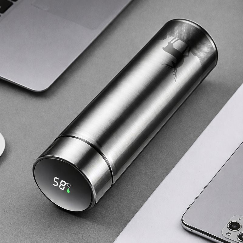 Silver thermos with digital temperature display on a gray surface