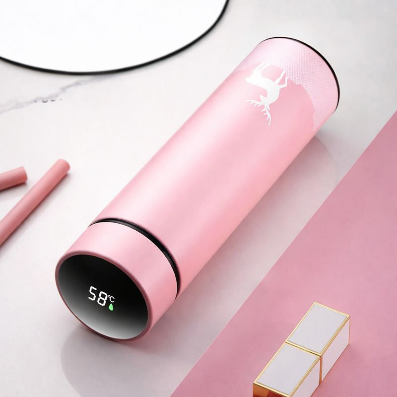 Pink water bottle with digital temperature display on a white surface