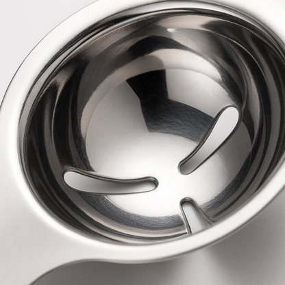 Close-up of a metallic kitchen tool on a white background