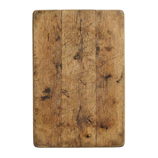 Worn wooden cutting board on a white background