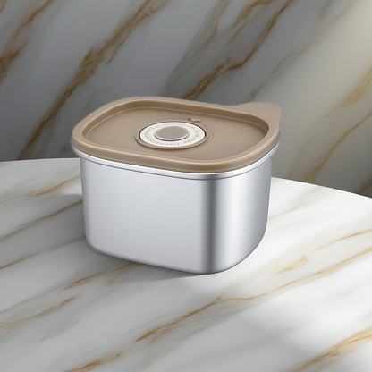 Metallic container with a beige lid on a marble surface