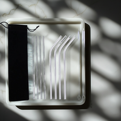 Set of metal straws in a clear plastic case on a marble surface