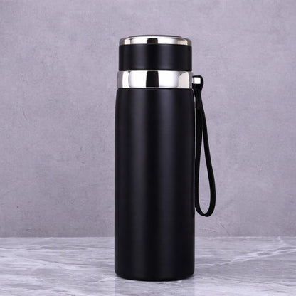Black insulated bottle with silver lid on a gray background