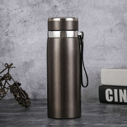 Stainless steel thermos bottle with a gray background